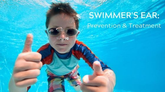 Boy underwater wearing goggles and giving two thumbs up