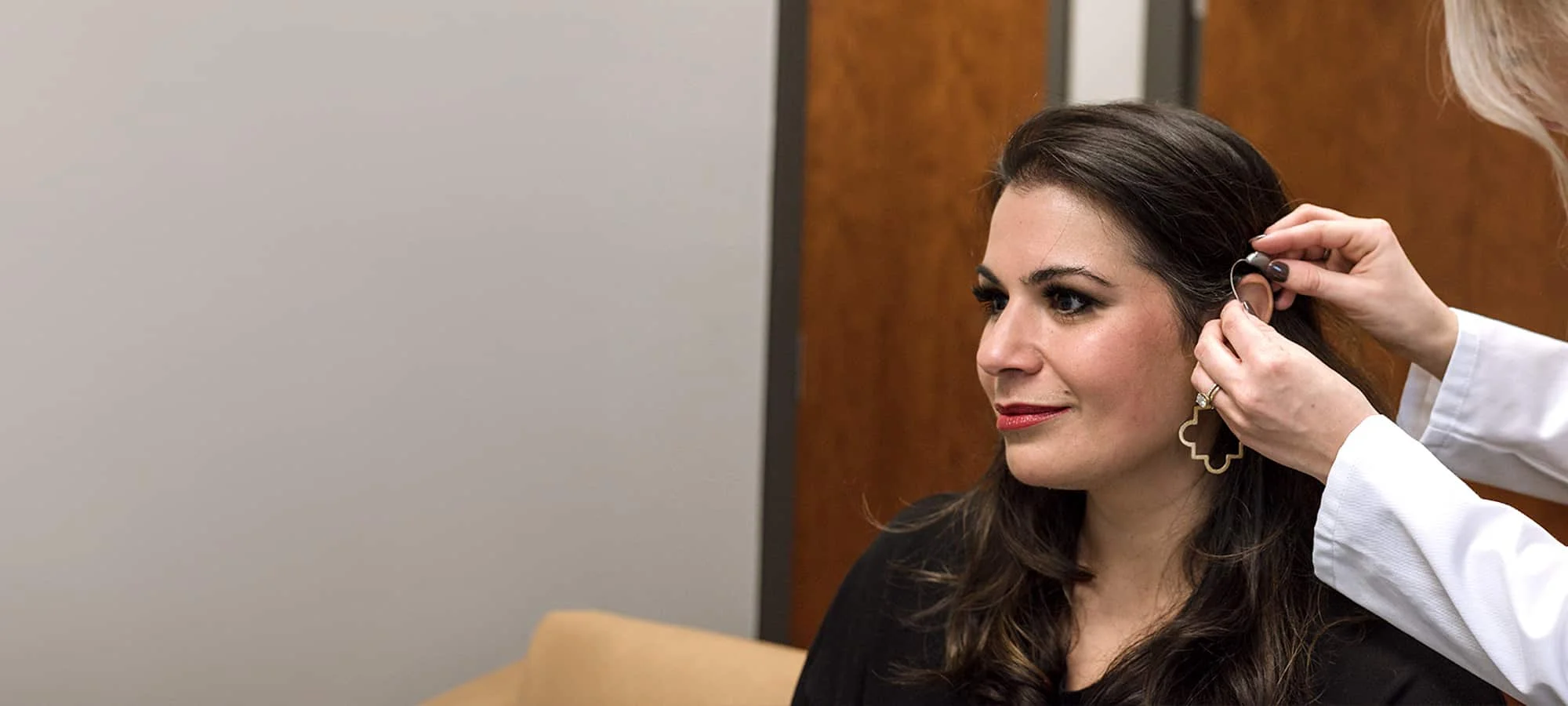 a woman wearing glasses and smiling at the camera